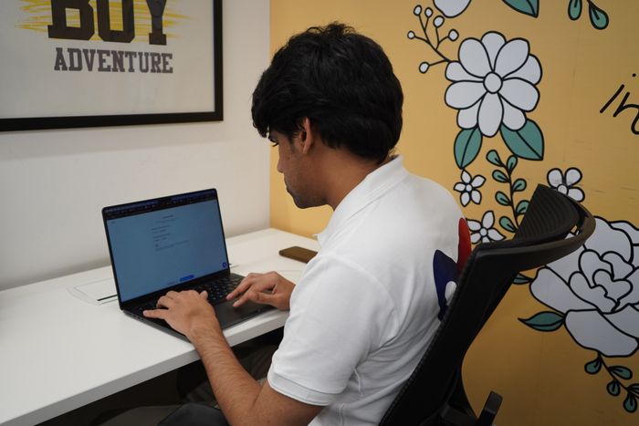 An Alliance Corporation team member working at a laptop
