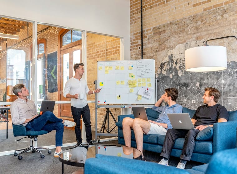 Delivery team working together in an open studio space