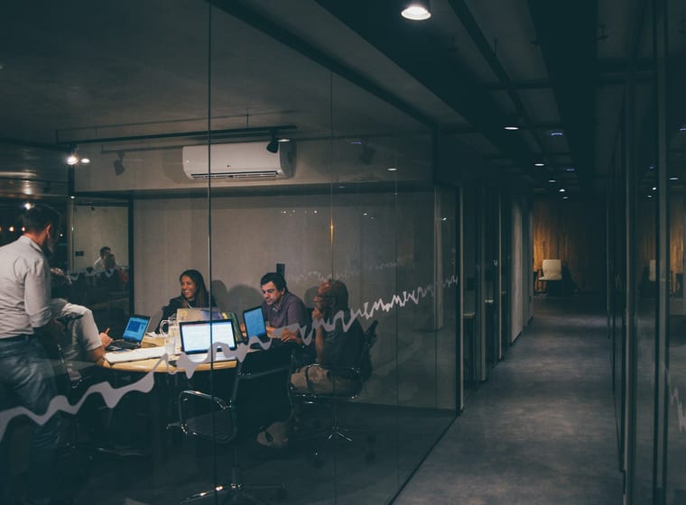 Operations team working late in a glass-walled office