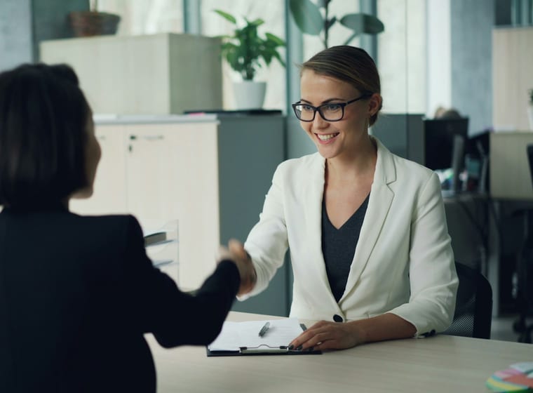 Consultant meeting a client across a desk